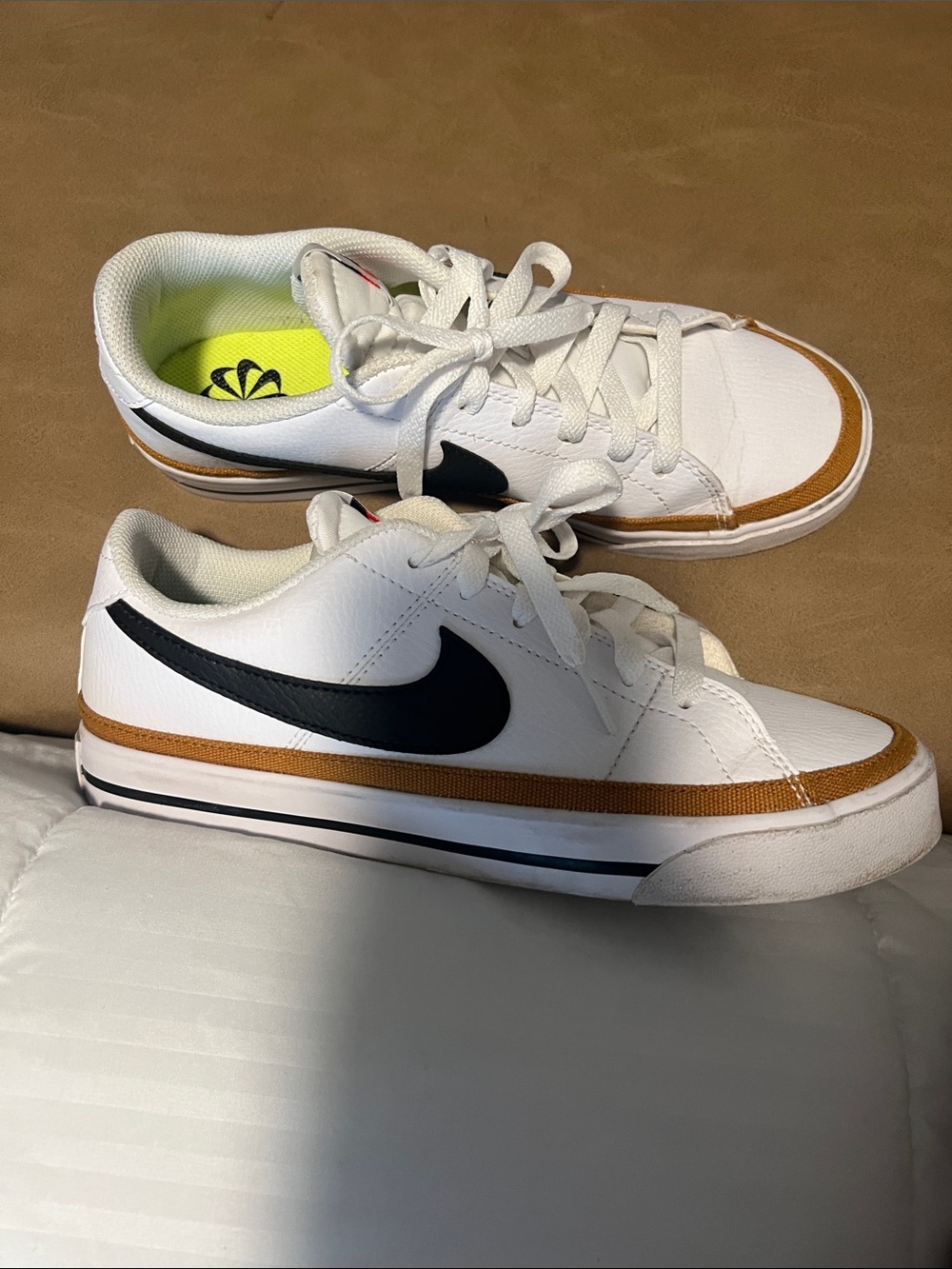 Nike White Low-Top Sneakers with Black Swoosh and Brown Trim